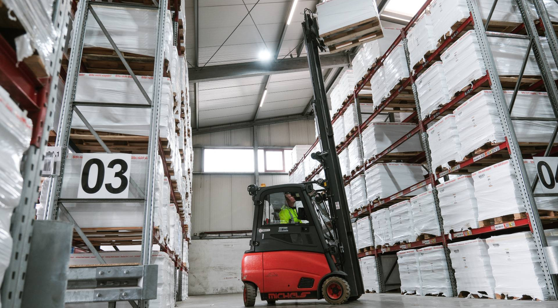 Gabelstapler in Lagerhaus mit Regalen.